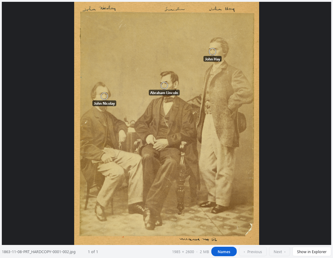 The second photograph, with the three source-identified people marked.